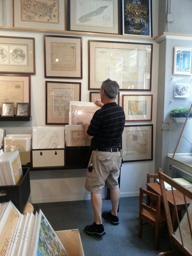 John Ranes examining the maps at Parrish Framing & Art