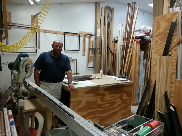 Cliff Wilson of Framed in Tatnuck stands in his moulding cutting room.