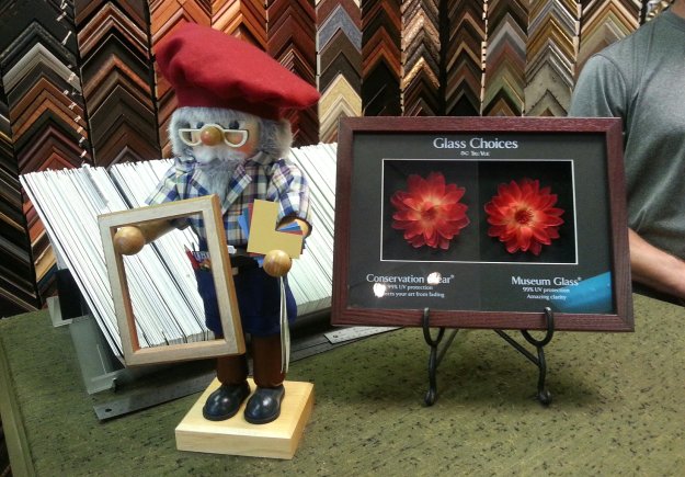 Picture Framer nutcracker joins Tru Vue Museum and Con Clear glass display - design counter - Village Framers